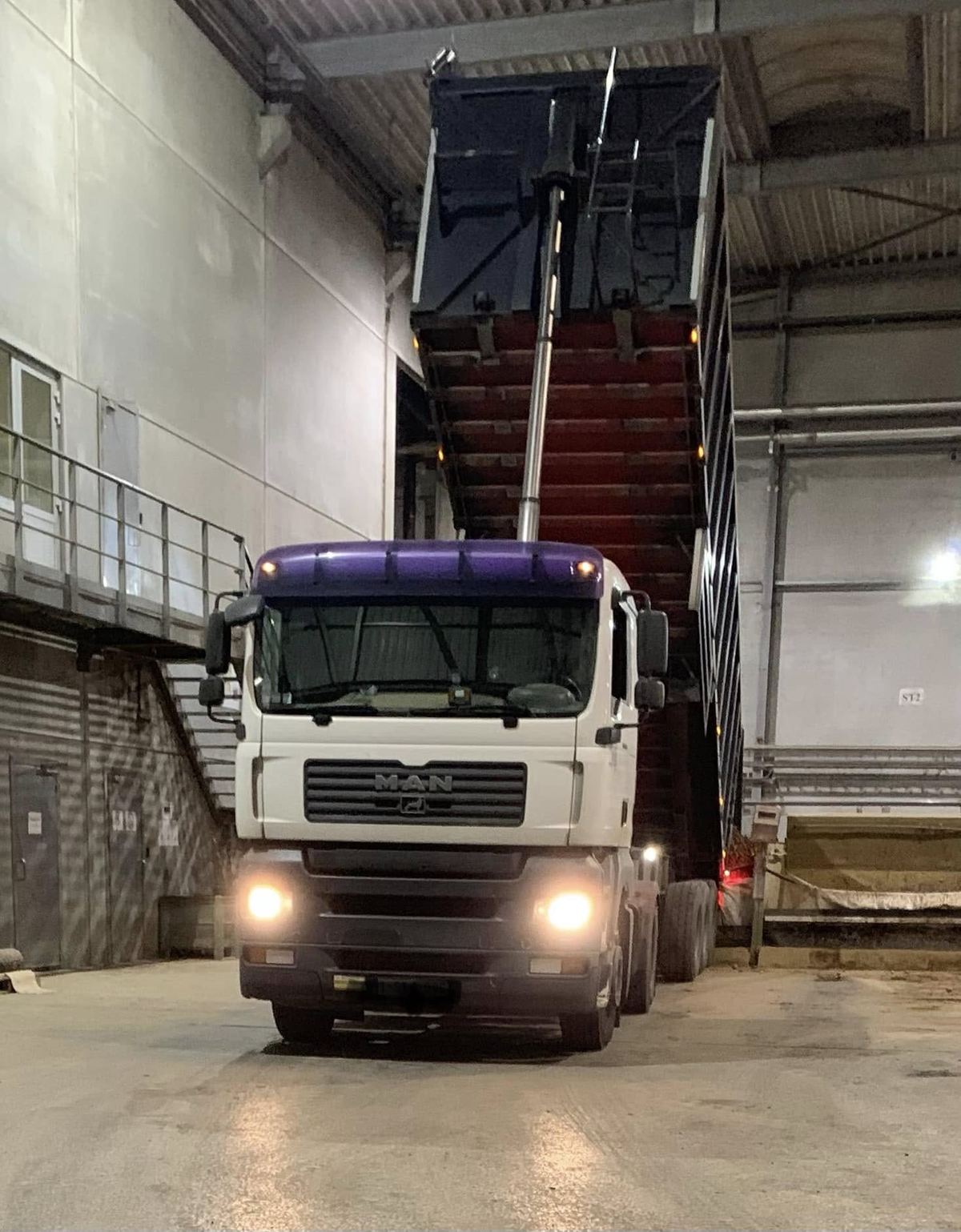 Vrachtwagen kipt zijn lading aardappelen in de loods
